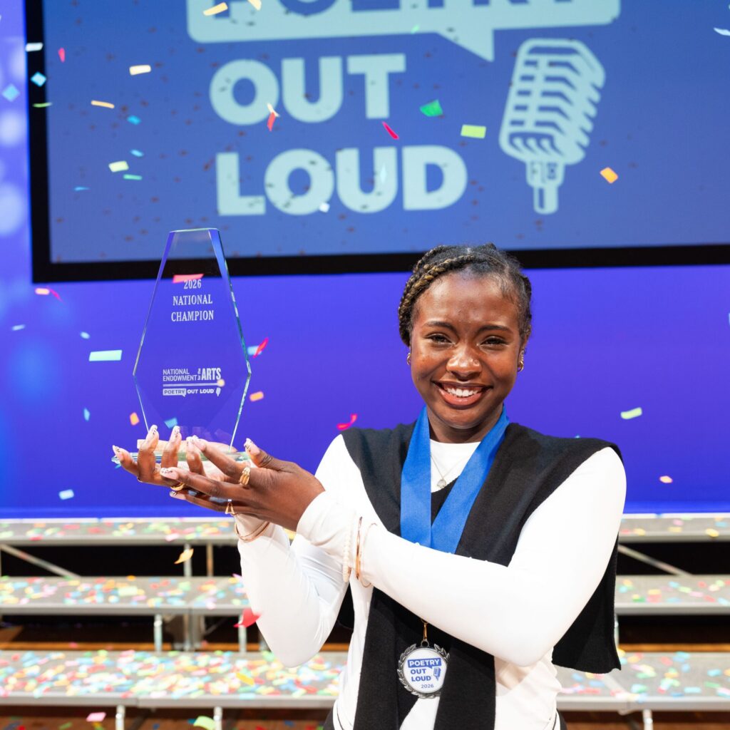 Jayda Dawn holds the National Champion tropht as confetti falls from above.