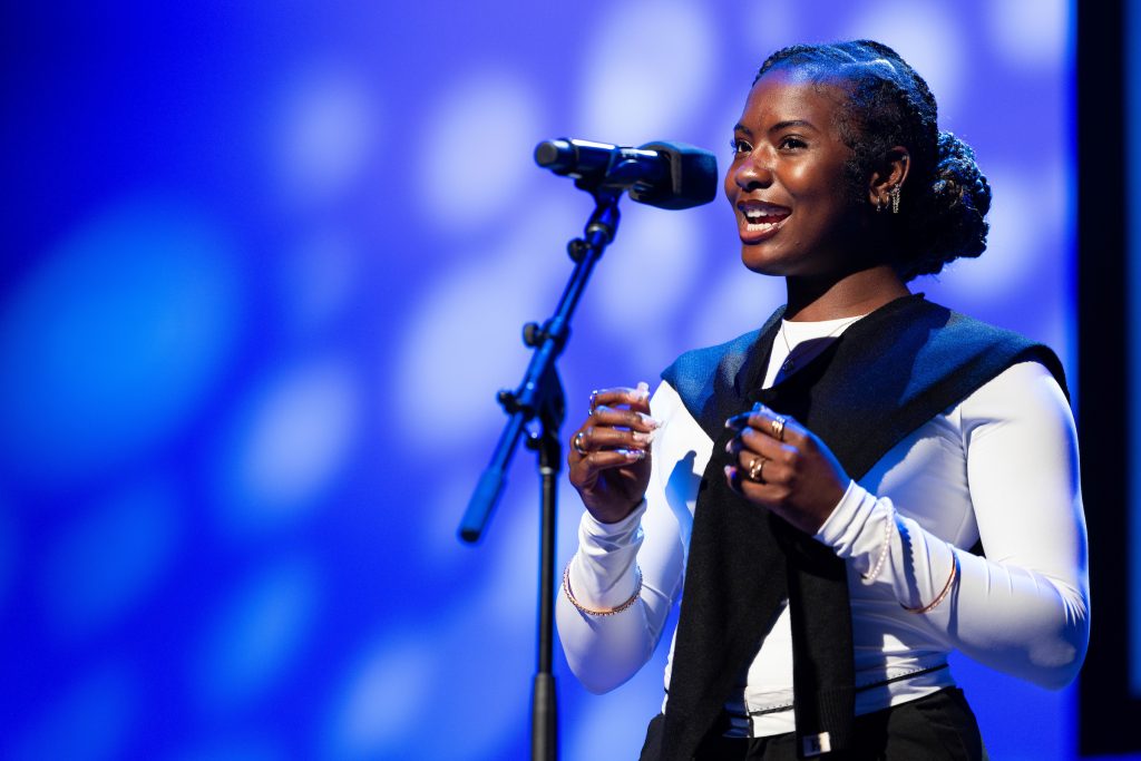 A student recites onstage.